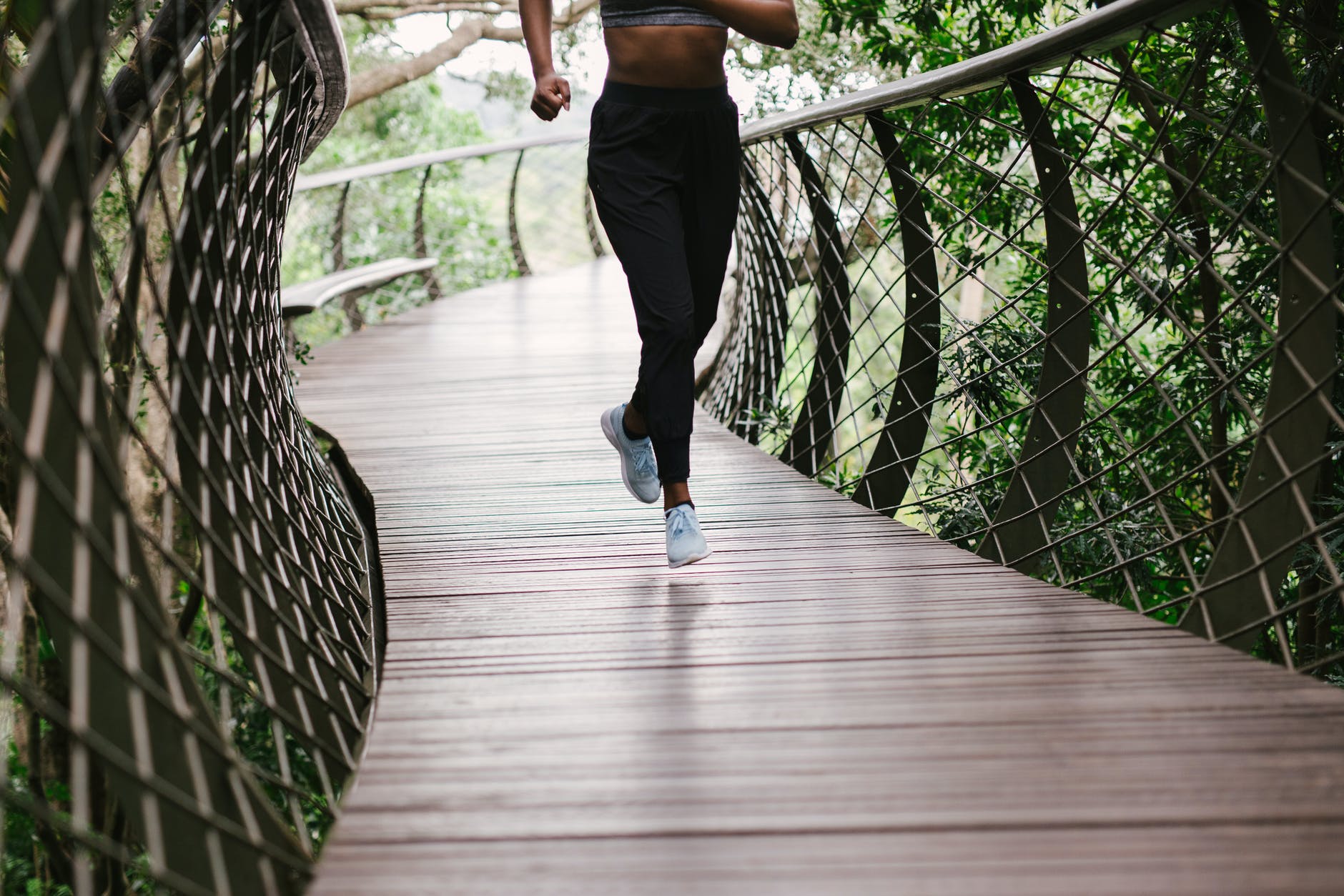 photo of person running on bridge